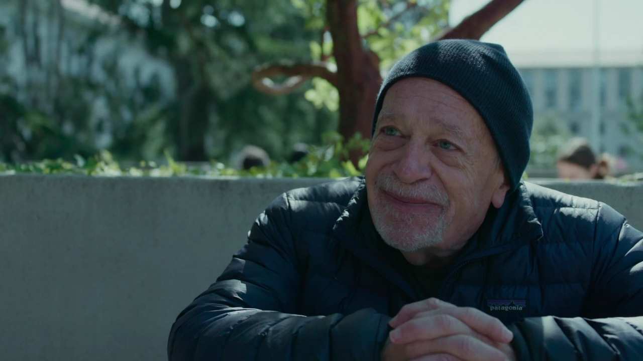 a man with a beard and wearing a toque